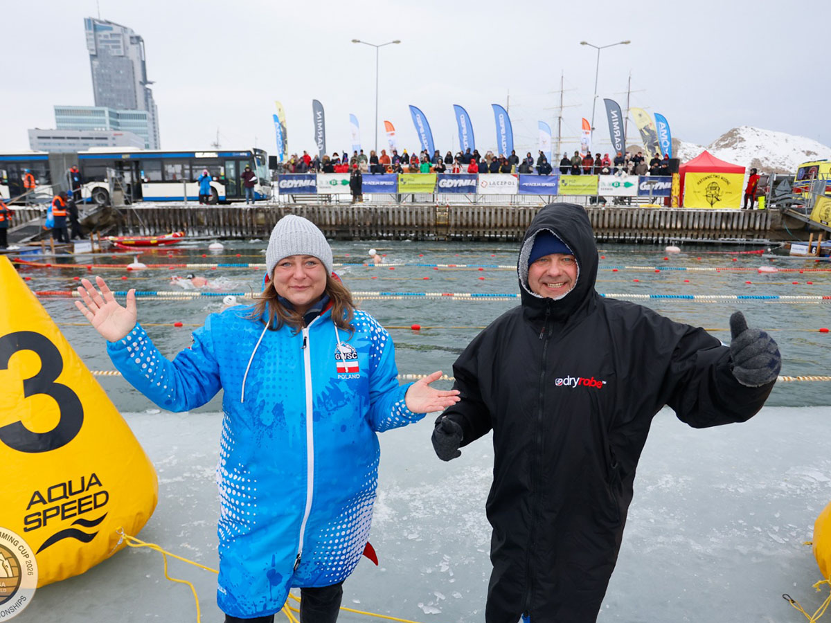 A man and a woman standing in front of winter swimming pool at the IWSA World Cup stage in Gdynia, Poland.